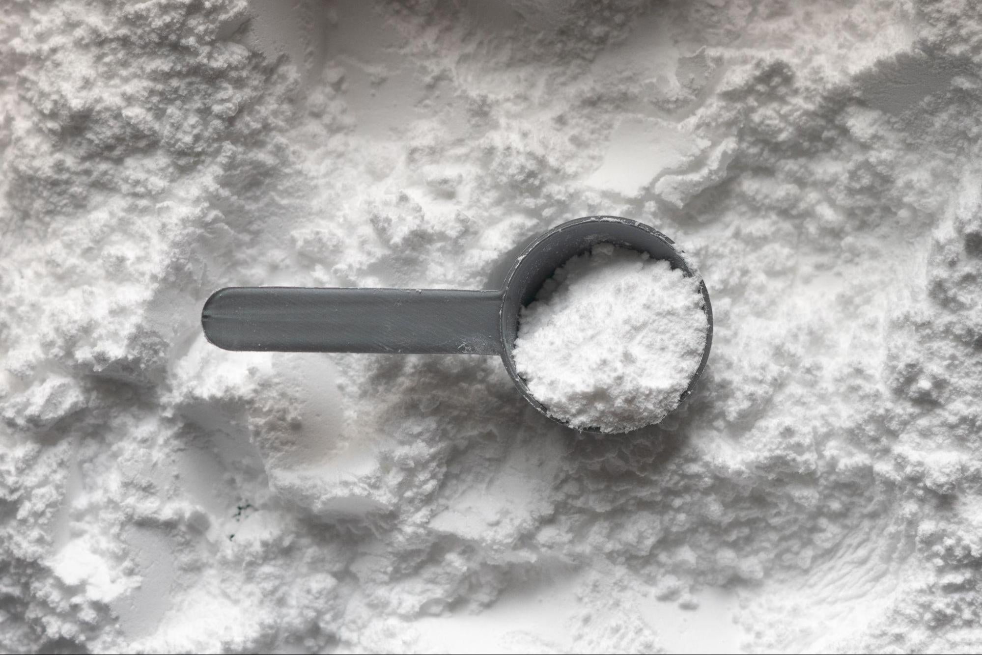 creatine powder with a scooper