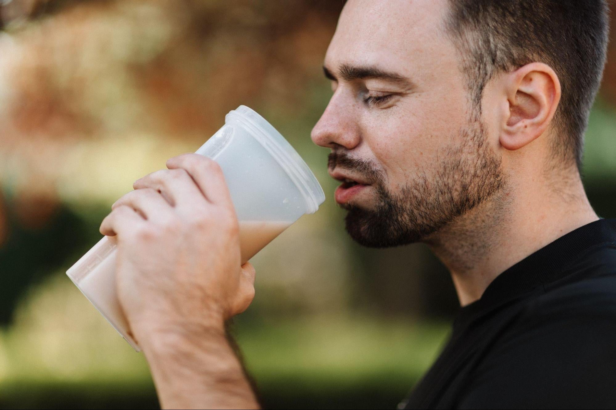 man drinking a muscle recovery shake