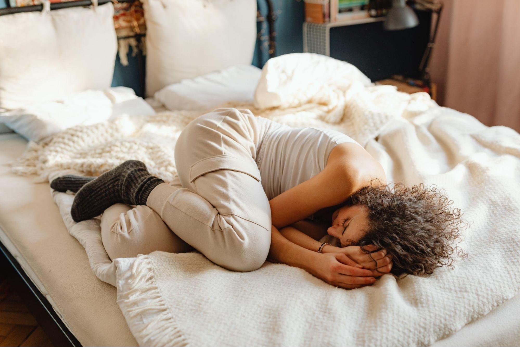 a woman sleeping on her bed