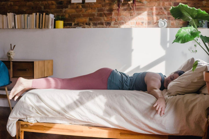 an athletic woman resting in bed