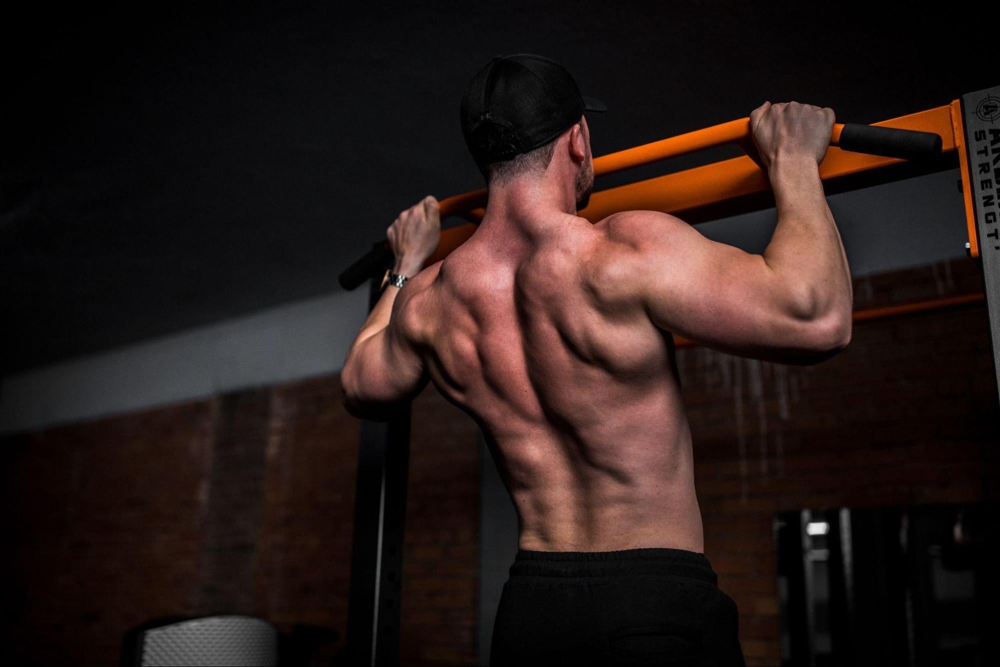  person with a strong back doing a pullup