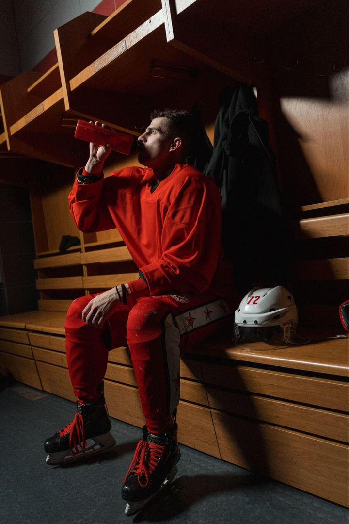 an athlete drinking a pre-workout shake