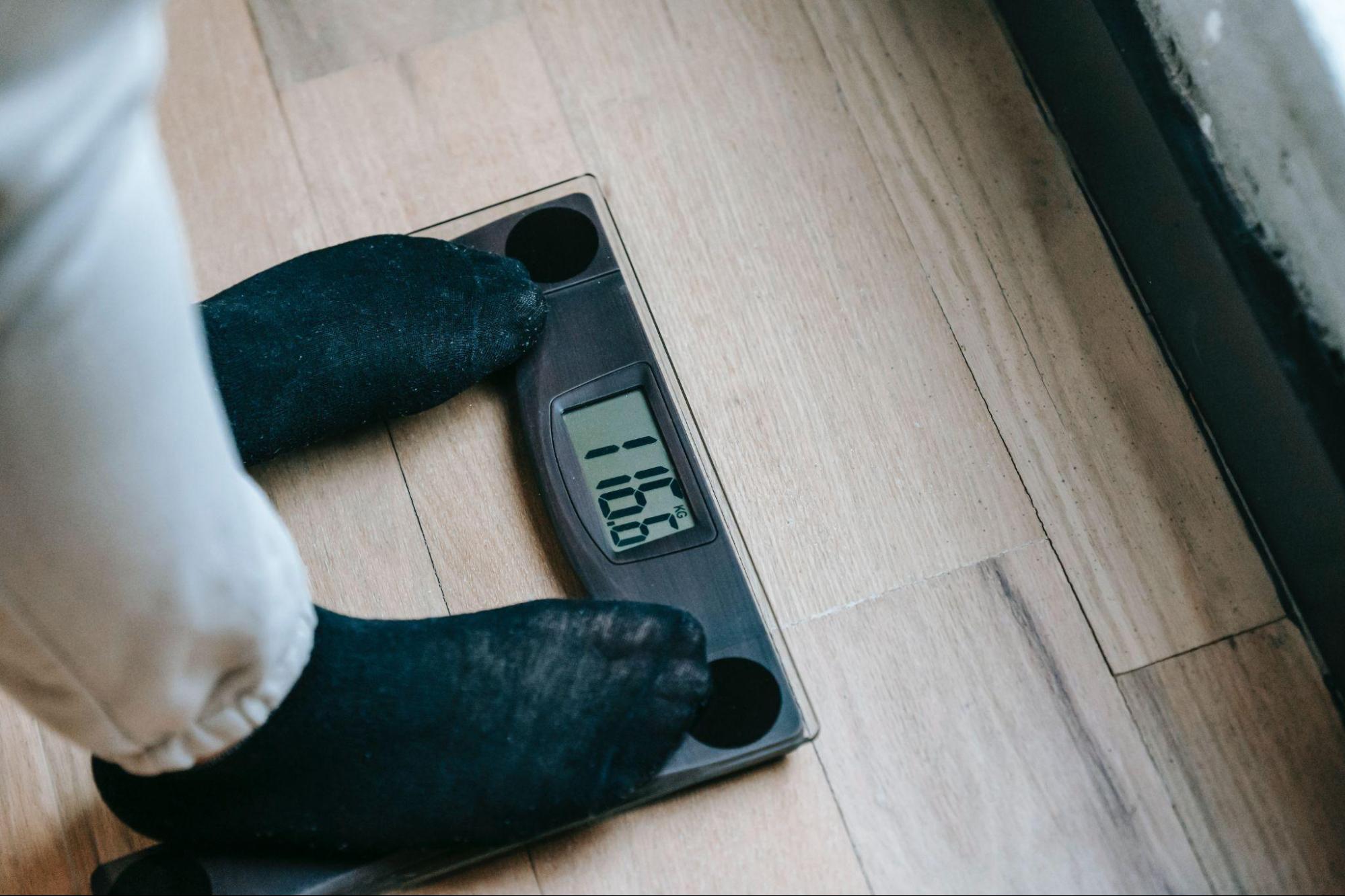 person stepping on a scale