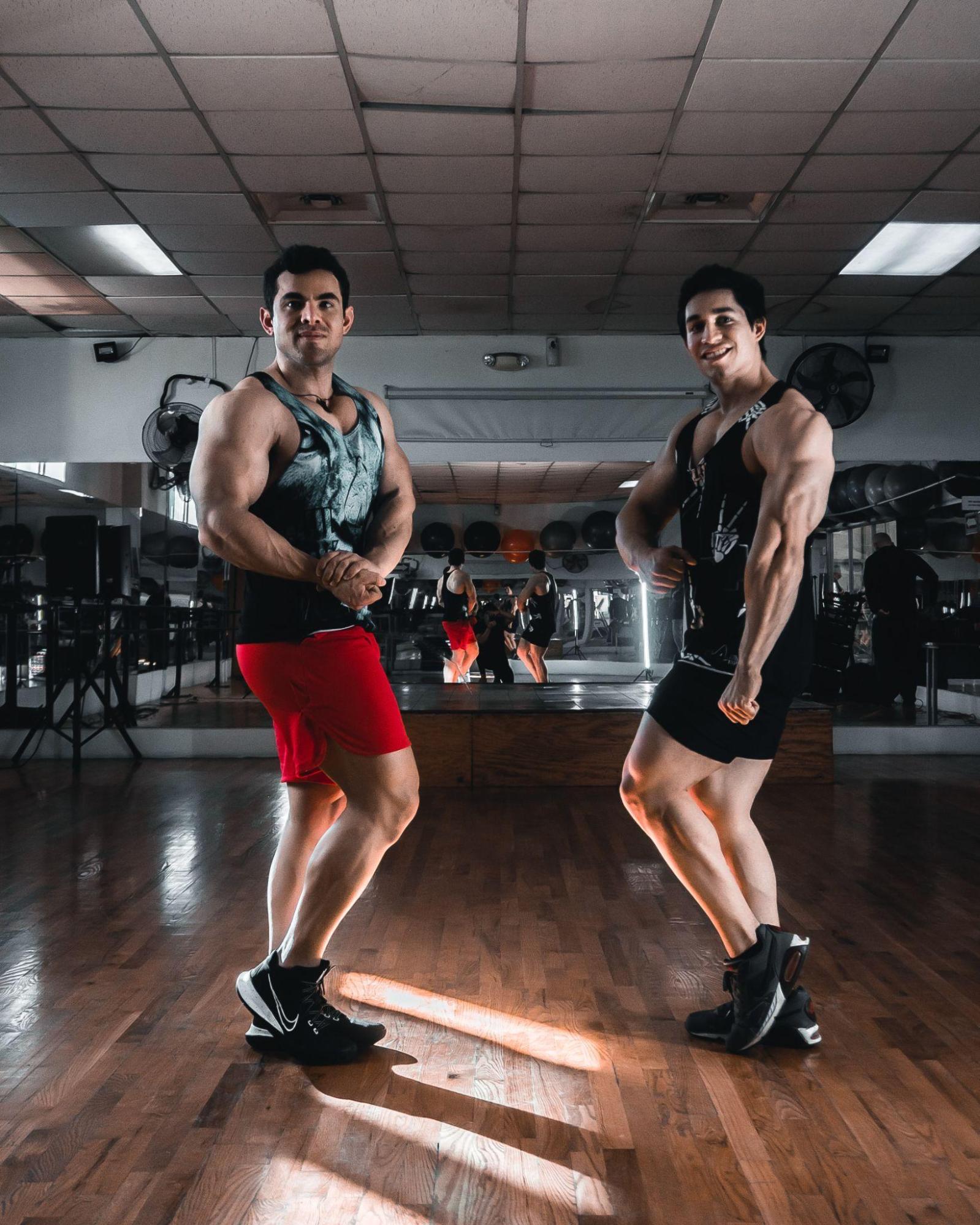  strongman and bodybuilder flexing