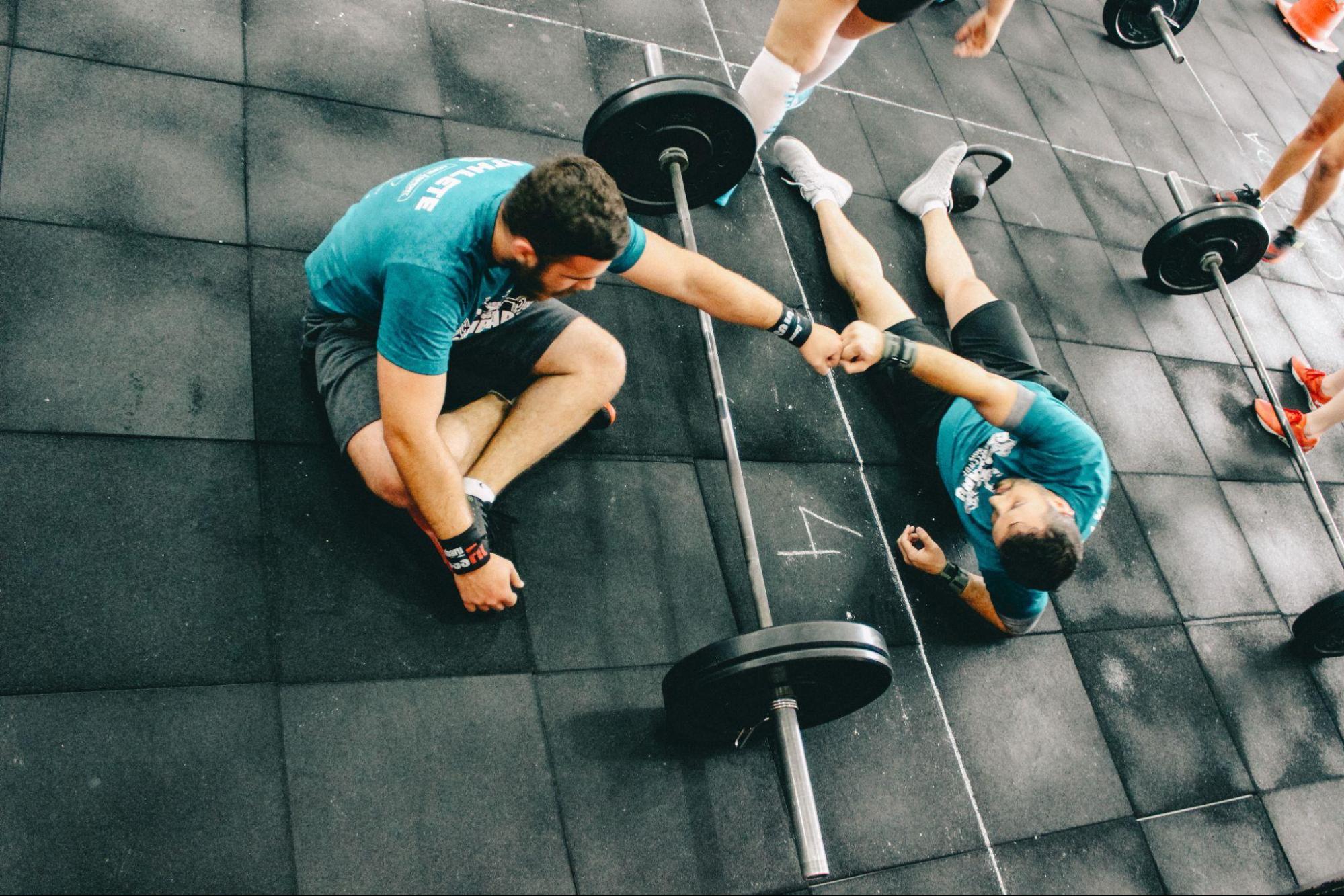 CrossFit coach helping another person