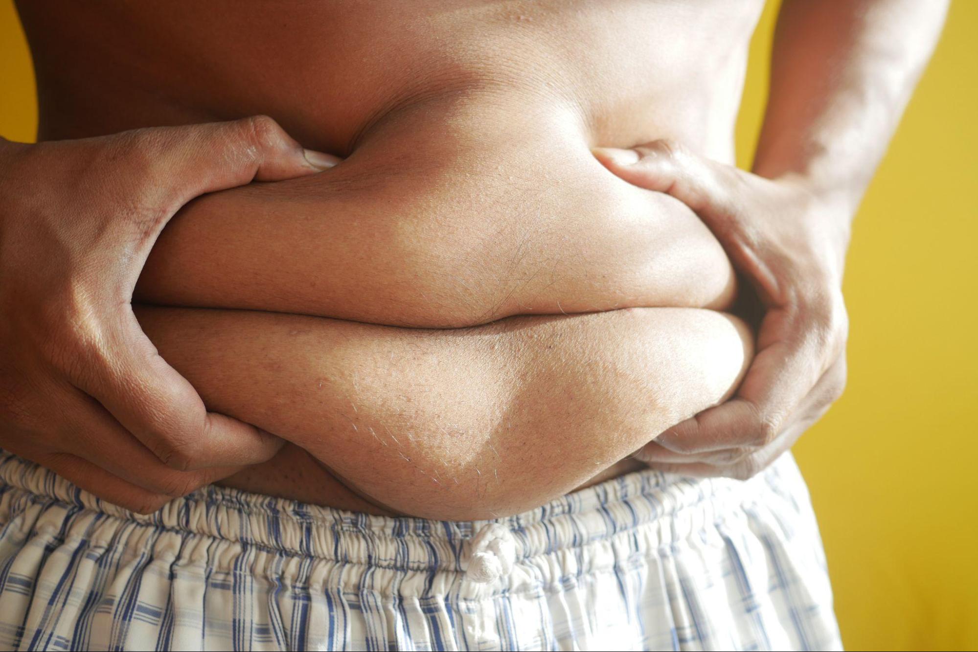 fat person grabbing belly