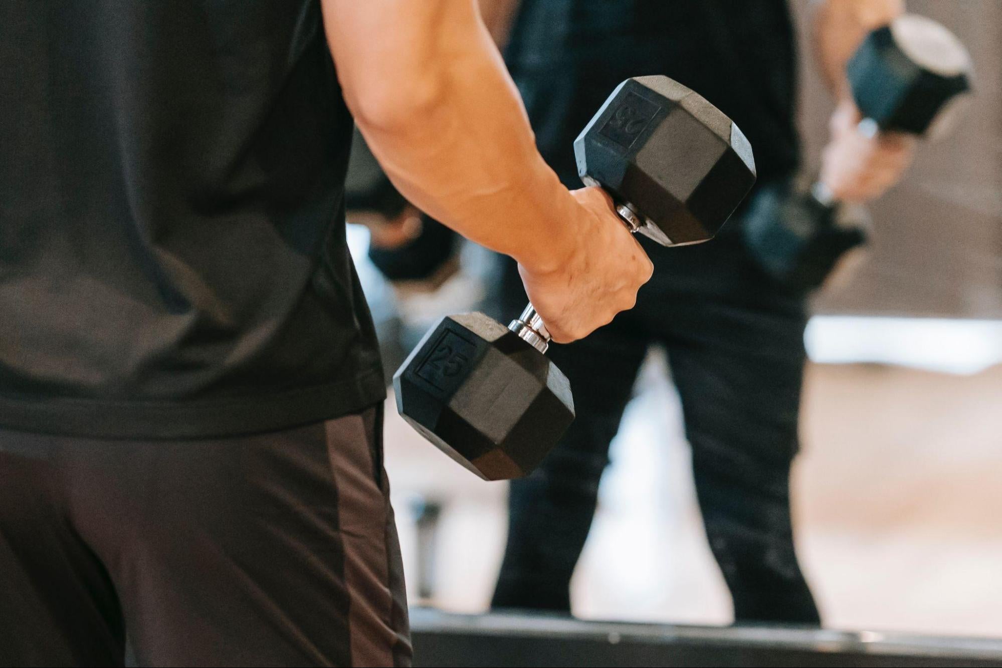 man using dumbbells