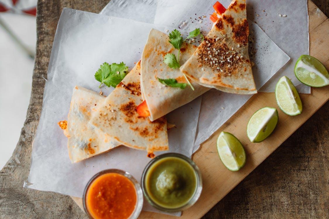  four quesadillas with salsa and cut limes 