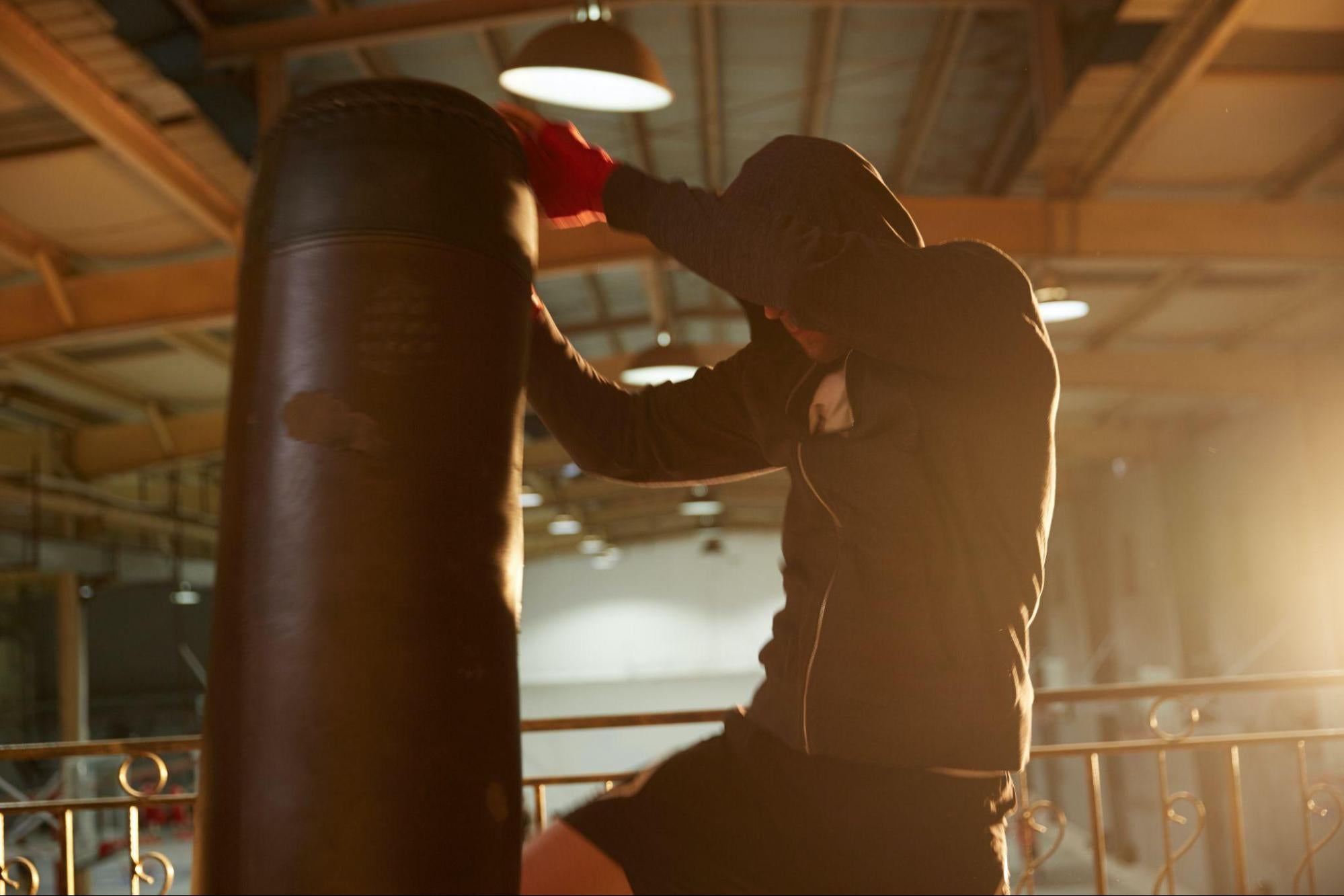 boxer exercising with punching bag