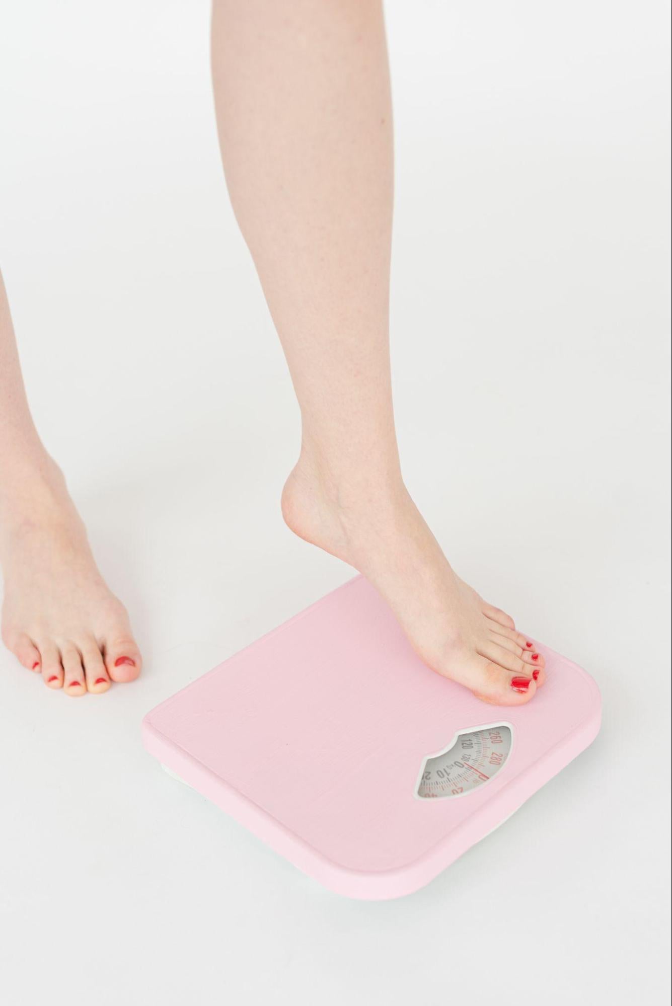 person standing on a weight scale