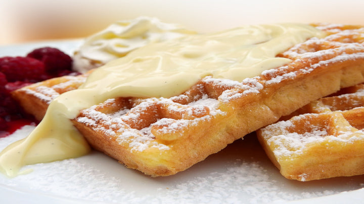 two waffles with custard and powdered sugar